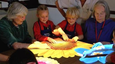 Pupils play a light game with care home residents