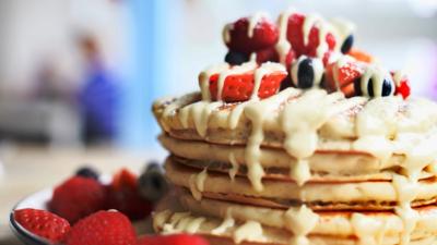 Pancake stack with fruit and melted white chocolate