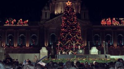 US President Bill Clinton overlooks crowds in front of a Christmas tree outside of Belfast City Hall.
