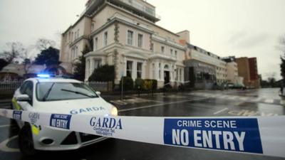 A police (Garda) cordon outside the Regency Hotel in Dublin, Ireland, after one man died and two others were injured following a shooting incident at the hotel, Friday Feb. 5, 2016.