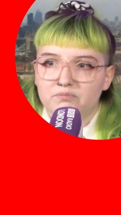 Veronique Hawksworth speaking into a purple BBC Radio London microphone with a London skyline background on the screen behind