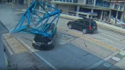 Crane crushes car