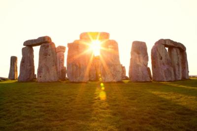 Sun shining through standing stones at Stonehenge