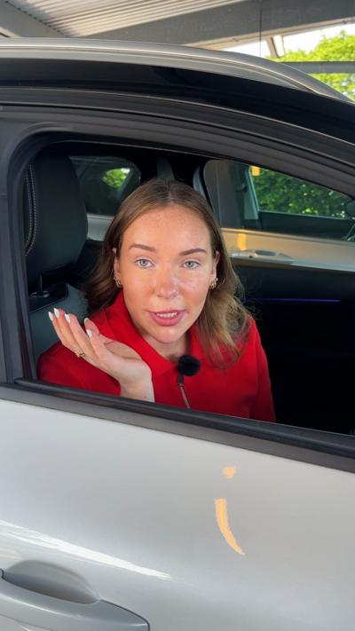 Megan looking at camera out car window