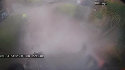 Image from CCTV footage showing smoke surrounding upside down bin 