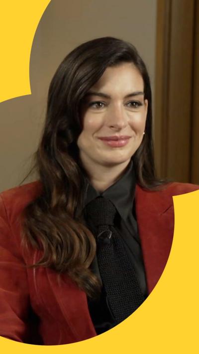 Anne Hathaway wearing a shirt and jacket 