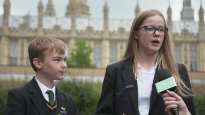 A-boy-and-a-girl-stood-at-Houses-of-Parliament