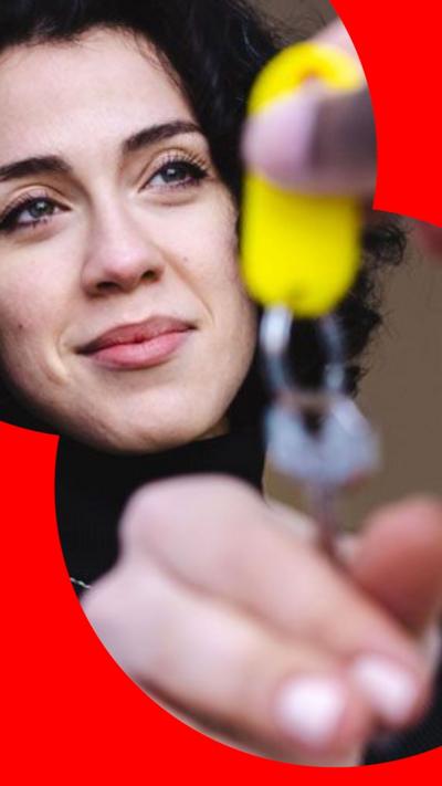A woman being handed a set of keys
