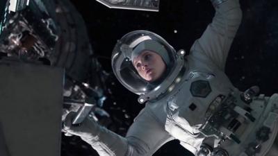 An in-post production shot from The Midnight Sky. Actress Felicity Jones is wearing a space suit