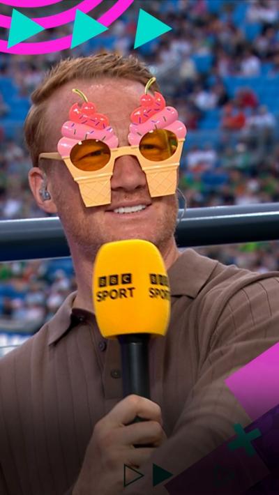 Greg Rutherford wearing ice cream glasses, holding a BBC Sport microphone at the European Athletics Championships 2026.