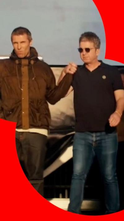 Liam and Noel Gallagher walk out on stage hand in hand