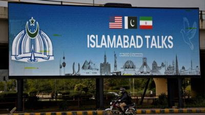 A billboard sign which says 'Islamabad Talks'.