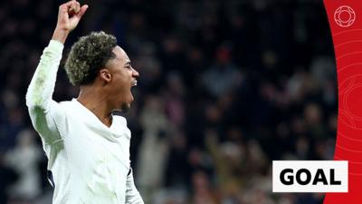 Wilson Odobert celebrates with fist in the air in Tottenham kit