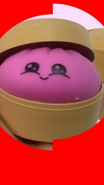 picture of a pink squishy inside a yellow circular container.