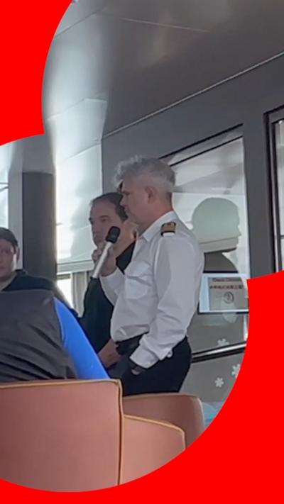 Ship captain talkimg into a microphone