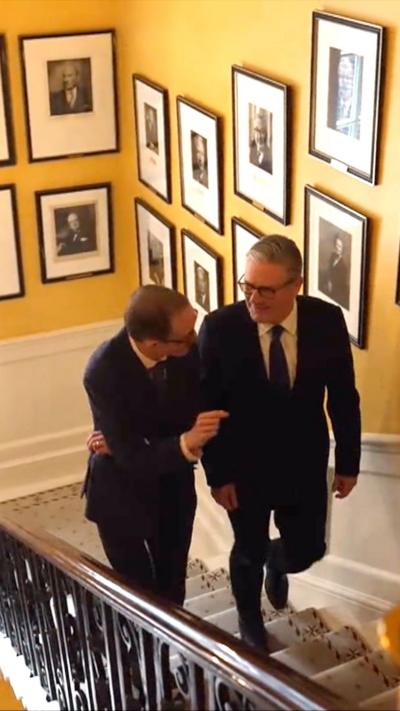 Chris Mason and Sir Keir Starmer walking up the Downing Street stairs