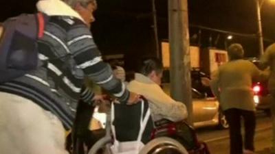 Man pushing wheelchair