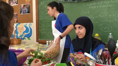 Women cutting food up