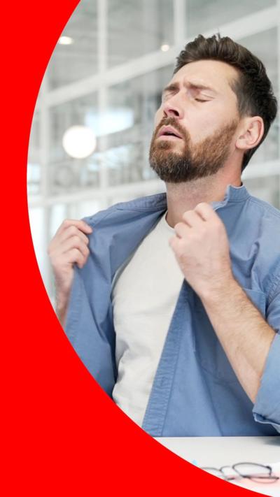 Man with eyes closed and holding blue shirt in his hands