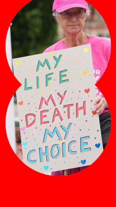 An older woman wearing a pink t-shirt and hat with a sign reading 'my life, my death, my choice' 