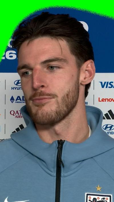 Declan Rice against a blue backdrop in a pre-match interview ahead of England v Argentina in the 2026 World Cup semi-finals