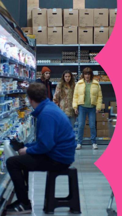 Deb, Josie and Billie Stand in a supermarket aisle with a man in a blue jacket in the foreground.