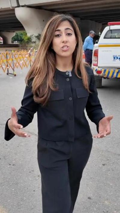 BBC South Asia correspondent Azadeh Moshiri speaks to camera in front of police vehicle in Islamabad