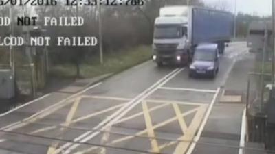 A lorry overtakes a van on a level-crossing in Lincolnshire