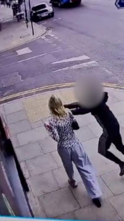 CCTV footage shows a phone being snatched from a woman in London.