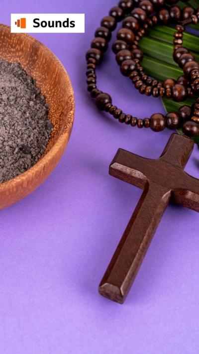 A bowl with ashes, a rosary and a palm leaf on a purple background