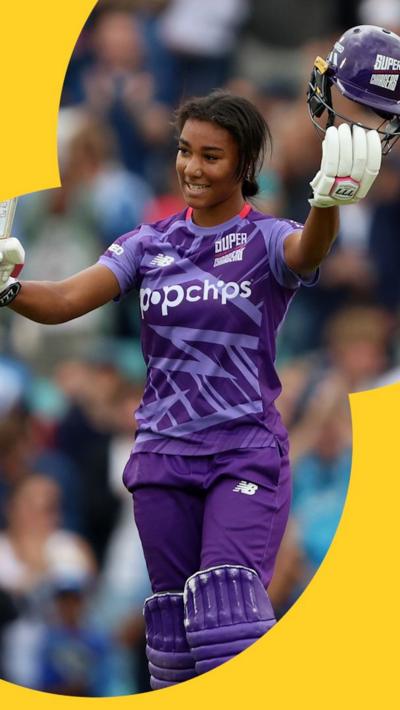 Davina Perrin holds up her cricket helmet