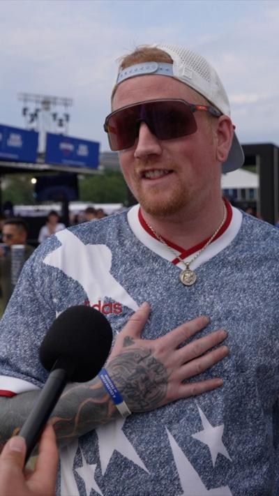 A man in a t shirt with stars on, a hat and sunglasses