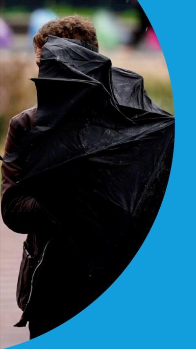 A person holds a broken unbrella