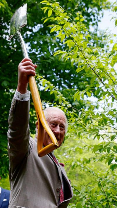 King Charles carries a shovel