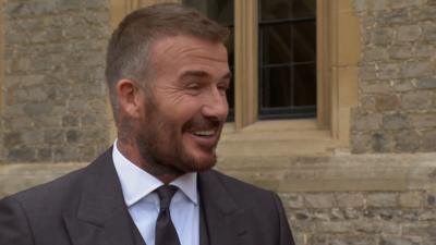Sir David Beckham smiles outside in Windsor