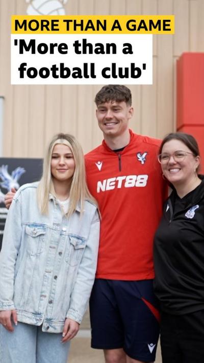 Jorgen Strand Larsen stood with a fan and a member of the community trust