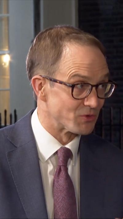 Chris Mason wears a suit