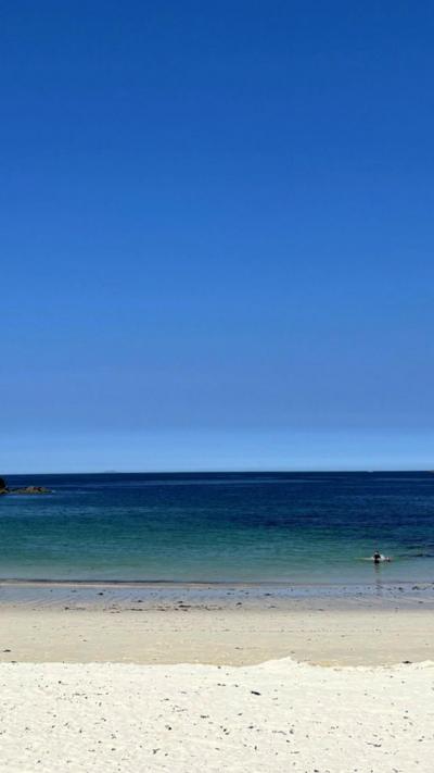 A beach with water and sand
