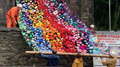 Flower netting being put on the tower