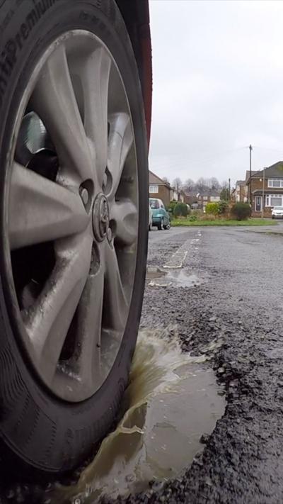 Tyre driving through pothole