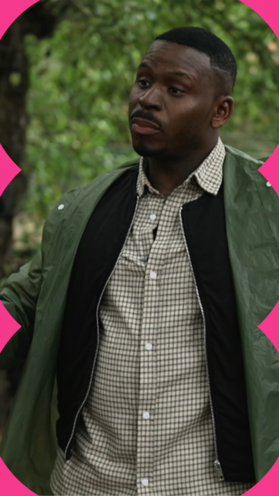 Fekky stands among trees wearing a green jacket. He has short black hair.