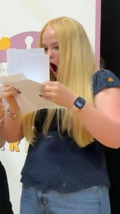 Girl gasping holding paper