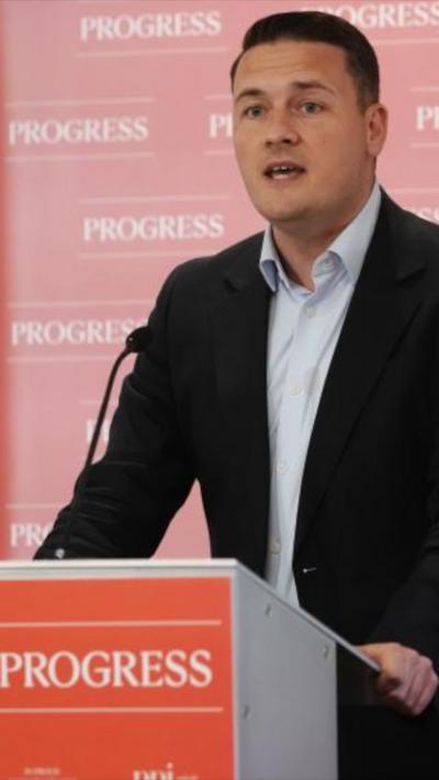 Wes Streeting standing at a podium with "podium" written on it 