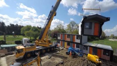 Y:Cube housing being moved into place