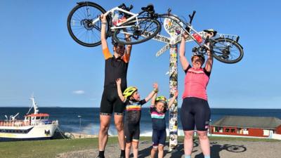 Jones family holding bikes