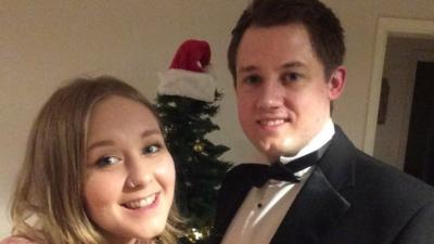 Simon and Becki - pictured in front of a Christmas tree