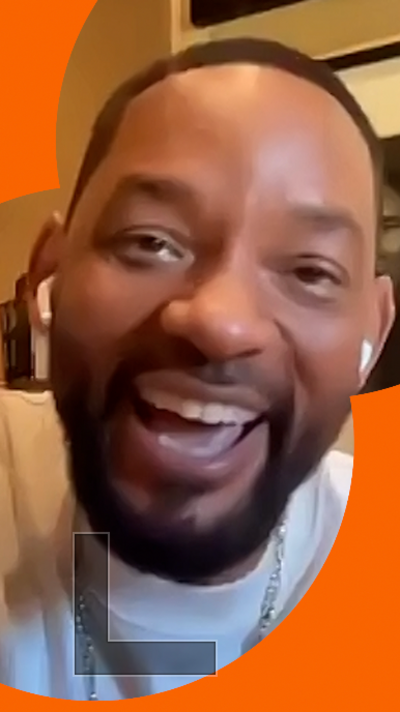 Actor Will Smith laughing while looking into a webcam during a BBC interview.