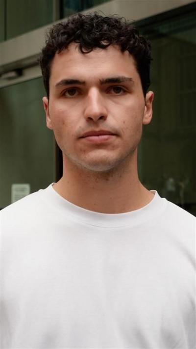 Man wearing white tshirt looking at the camera