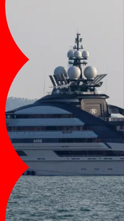 A large white superyacht floating on water.