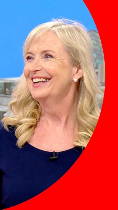 Carol sat on the Breakfast sofa and smiling